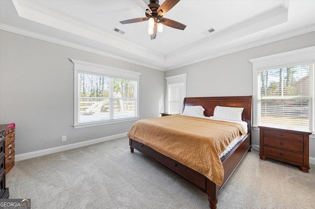 carpeted bedroom featuring crown molding, ceiling fan, a raised ceiling, and multiple windows