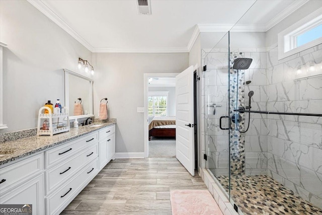 bathroom with crown molding, vanity, a shower with door, and hardwood / wood-style flooring