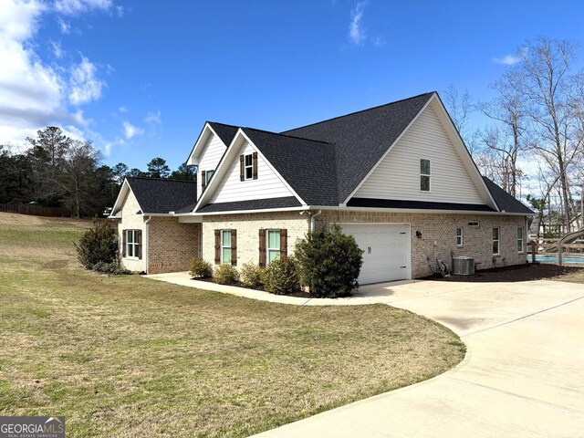 view of front of home featuring a front yard and central air condition unit