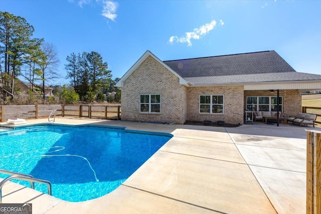 view of pool with a patio area, fence, and a fenced in pool