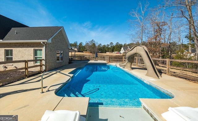 view of pool with a water slide