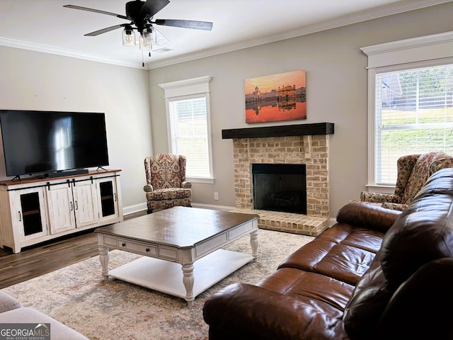 living room with ornamental molding, a healthy amount of sunlight, and dark wood-style floors