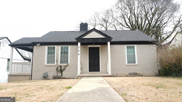 bungalow-style home with a front lawn