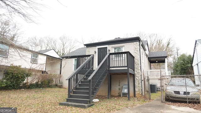 rear view of property featuring cooling unit