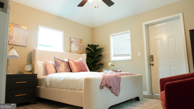 bedroom featuring multiple windows and ceiling fan