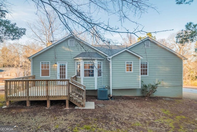 back of property featuring central AC unit and a deck