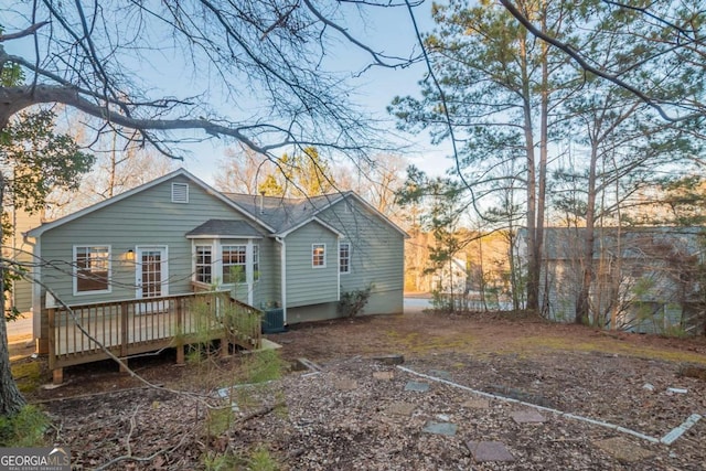 rear view of property featuring central AC unit and a deck