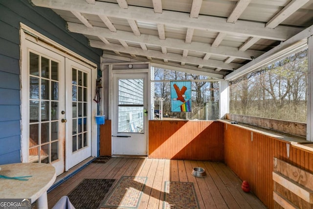 sunroom / solarium featuring vaulted ceiling with beams and french doors