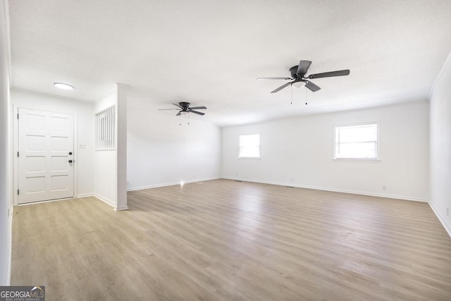 empty room featuring ceiling fan and light wood-type flooring