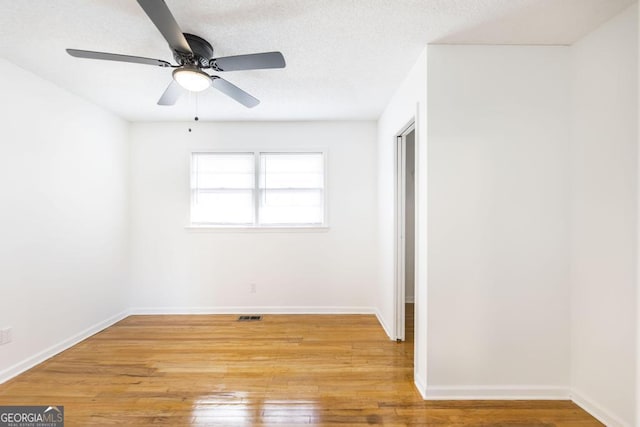 unfurnished bedroom with a closet, ceiling fan, a textured ceiling, and light hardwood / wood-style flooring