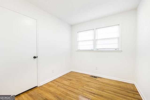 unfurnished room featuring wood-type flooring