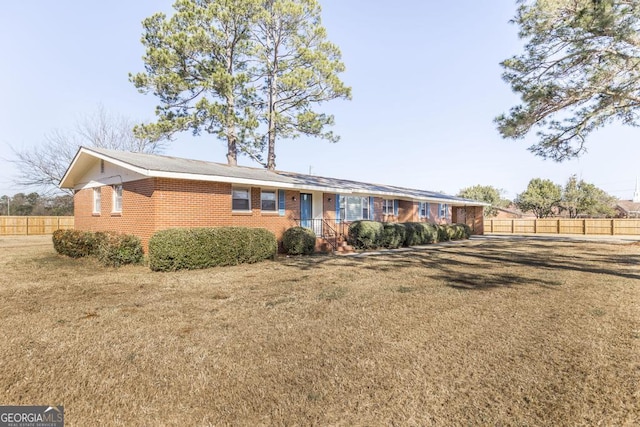 ranch-style home featuring a front yard