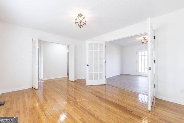 unfurnished room with wood-type flooring