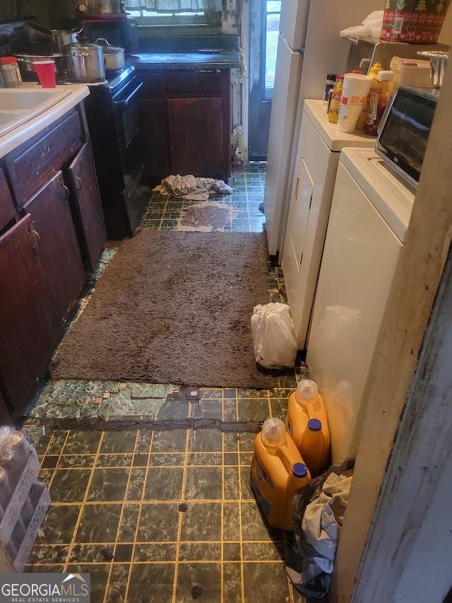 interior space featuring black range with electric stovetop and separate washer and dryer