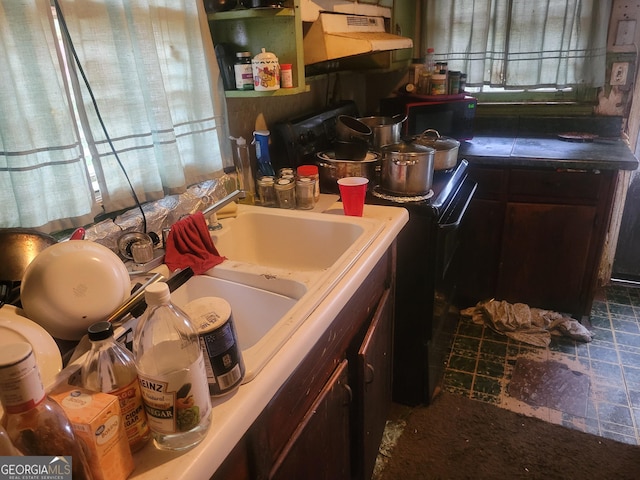 kitchen featuring range and dark brown cabinetry