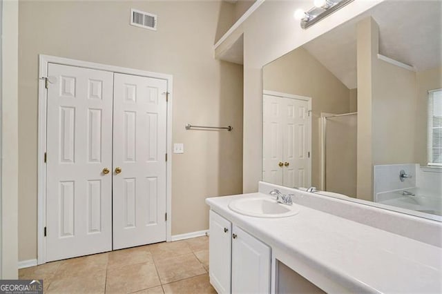 bathroom with tile patterned floors, separate shower and tub, and vanity