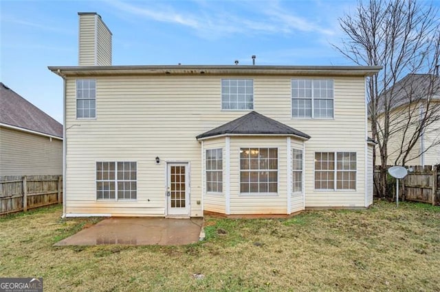 back of property featuring a yard and a patio