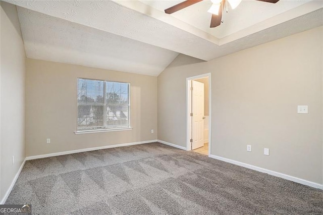 carpeted spare room featuring lofted ceiling, ceiling fan, and a textured ceiling