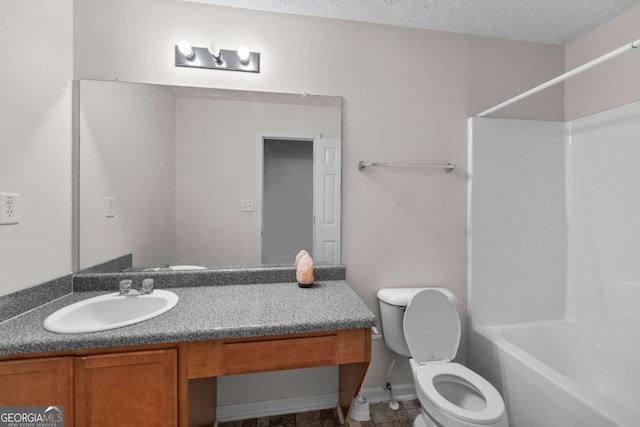 full bathroom with vanity, toilet, tub / shower combination, and a textured ceiling