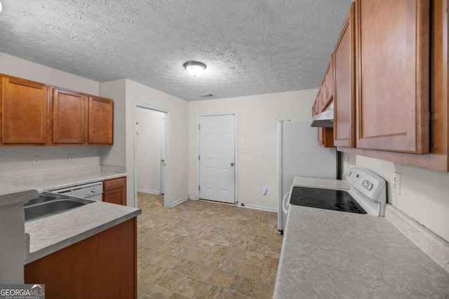 kitchen with white electric stove, sink, and a textured ceiling