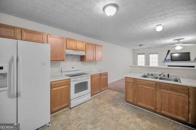 kitchen featuring sink, a textured ceiling, and white appliances