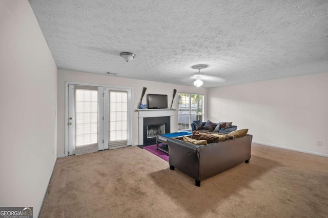 carpeted living room featuring a textured ceiling