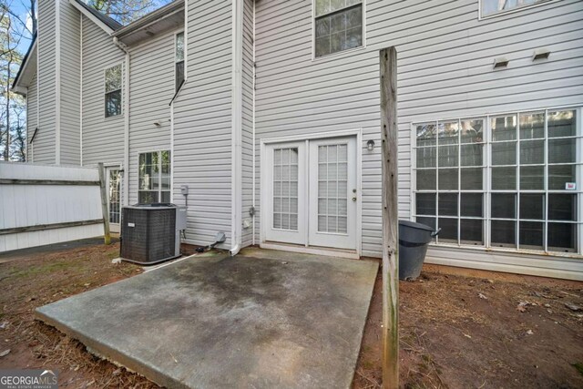 rear view of property featuring cooling unit and a patio