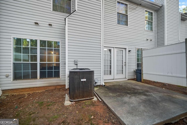 rear view of property featuring a patio area and central air condition unit