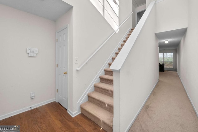 stairway featuring wood-type flooring