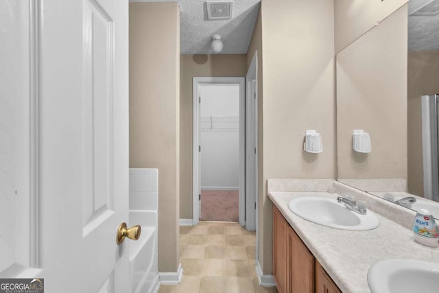 bathroom featuring vanity and a textured ceiling