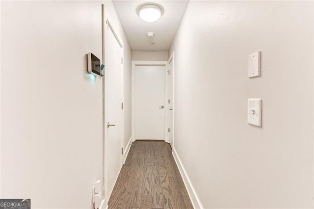 corridor with wood-type flooring