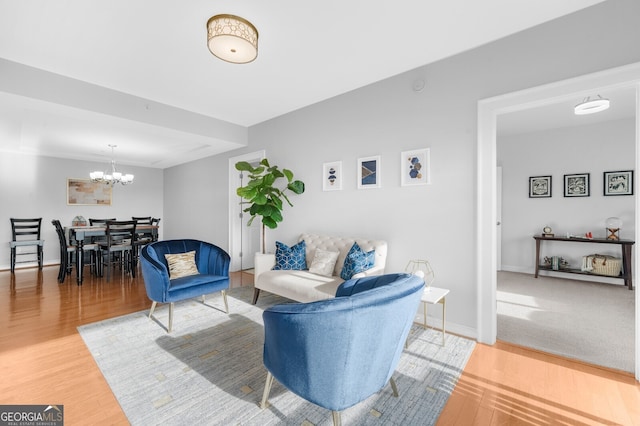 living room with hardwood / wood-style floors and a chandelier