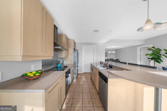 kitchen with sink, black appliances, wall chimney exhaust hood, and light brown cabinets