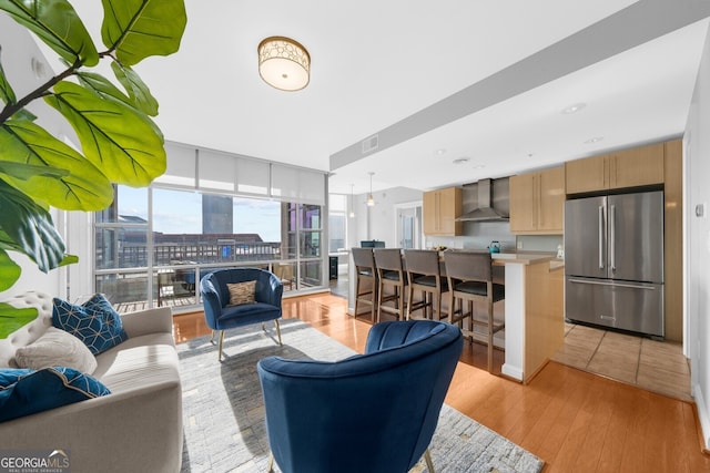 living room with light hardwood / wood-style floors and expansive windows