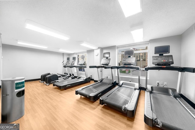 workout area with hardwood / wood-style floors and a textured ceiling