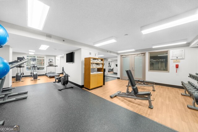 exercise room featuring a textured ceiling