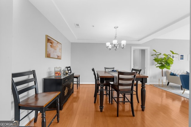 dining room featuring a chandelier and light wood-type flooring