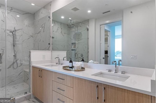 bathroom with vanity and a shower with door