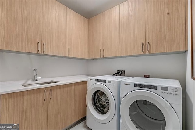 laundry area with cabinets, sink, and independent washer and dryer