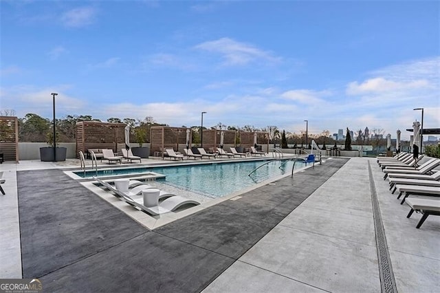 view of swimming pool featuring a patio area