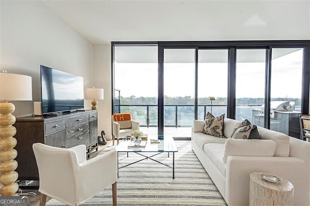 living room with expansive windows and a water view