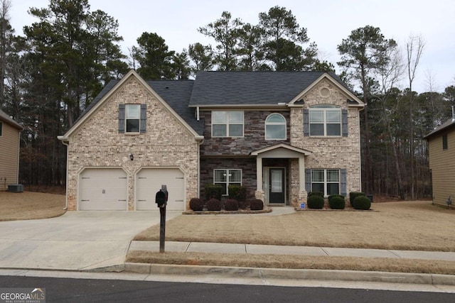 view of front of property with a garage and cooling unit