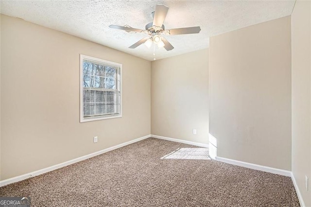 carpeted spare room featuring ceiling fan and a textured ceiling