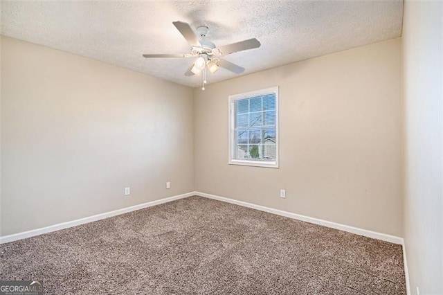 empty room featuring ceiling fan, carpet floors, and a textured ceiling