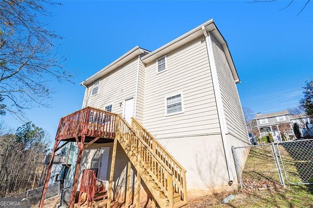 rear view of property featuring a deck