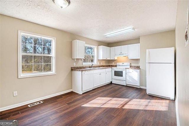 kitchen featuring white cabinetry, white appliances, dark wood-type flooring, and a textured ceiling