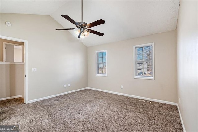 unfurnished room with ceiling fan, lofted ceiling, and carpet floors