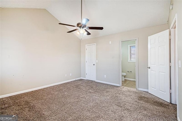 unfurnished bedroom with lofted ceiling, light colored carpet, ceiling fan, and ensuite bathroom