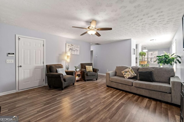 living room featuring ceiling fan, dark hardwood / wood-style floors, and a textured ceiling