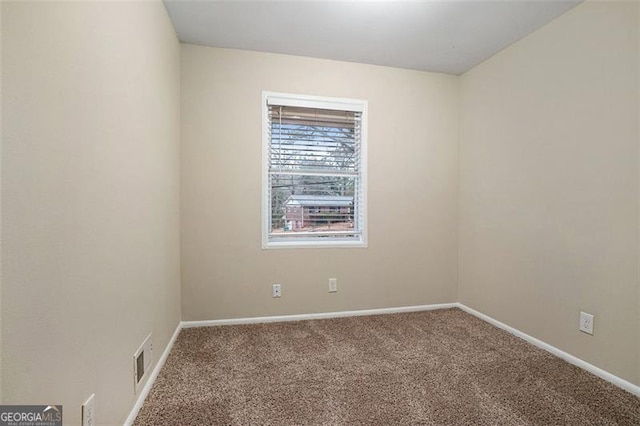 spare room featuring carpet floors